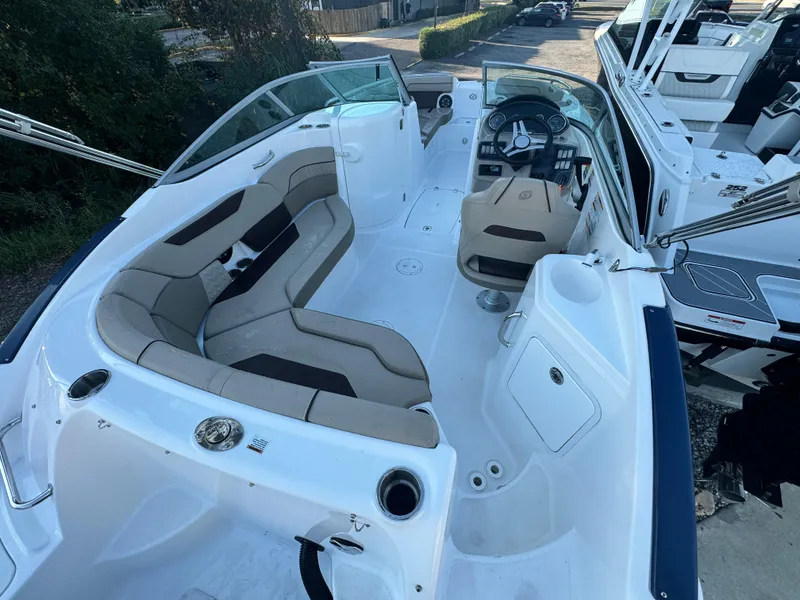 Slide: The Image of 2023 Hurricane SunDeck 2200 DC OB boat interior with spacious seating and modern dashboard. - 19