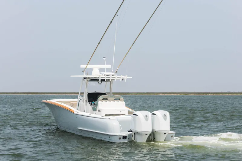 Slide: The Image of 2017 Mag Bay 33cc boat with dual outboard engines on the water. - 5