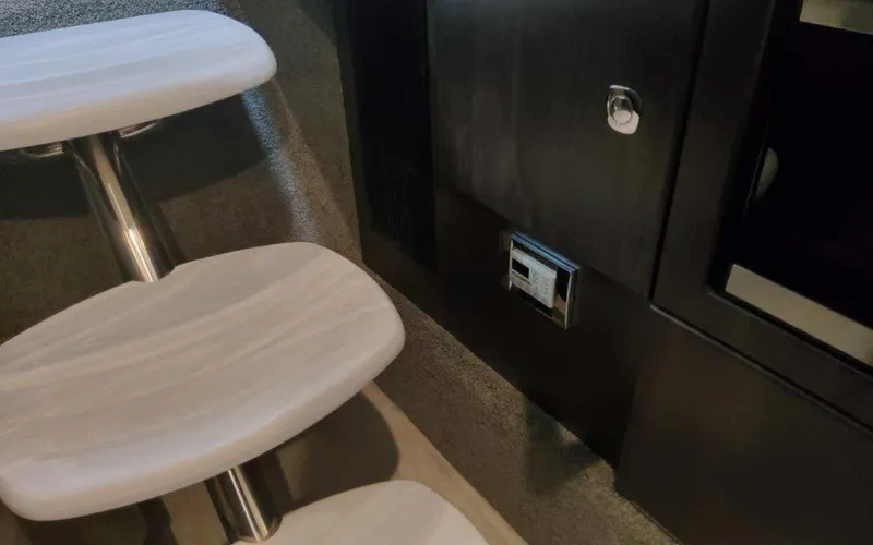 Slide: The Image of Interior of 2025 Formula 330 Crossover Bowrider I/O, featuring sleek wooden steps and modern design. - 15