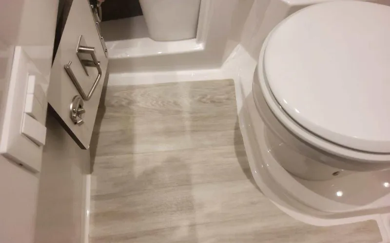 Slide: The Image of 2025 Formula 330 Crossover Bowrider I/O bathroom with modern fixtures and wood-style flooring. - 18