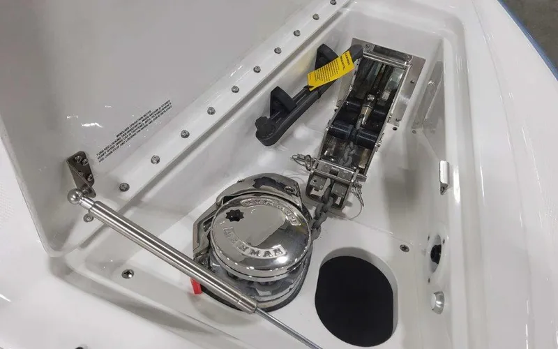 Slide: The Image of 2025 Formula 330 Crossover Bowrider I/O anchor compartment with winch and hydraulic support. - 23