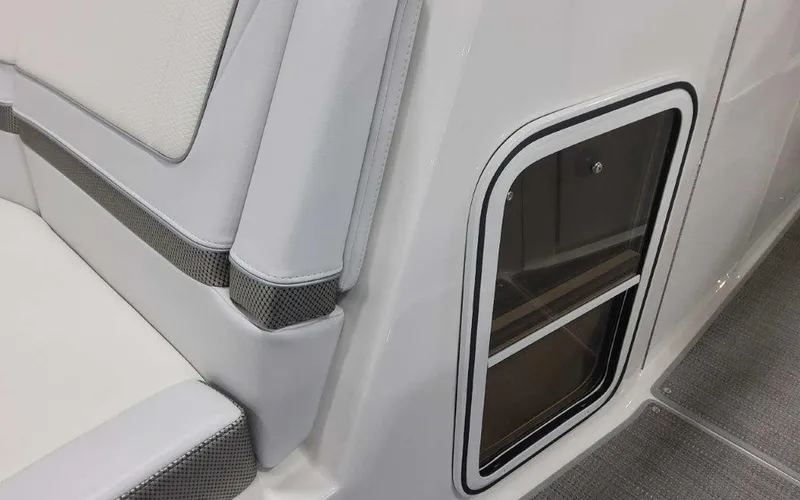 Slide: The Image of 2025 Formula 330 Crossover Bowrider I/O interior detail with sleek seating and storage compartment. - 24