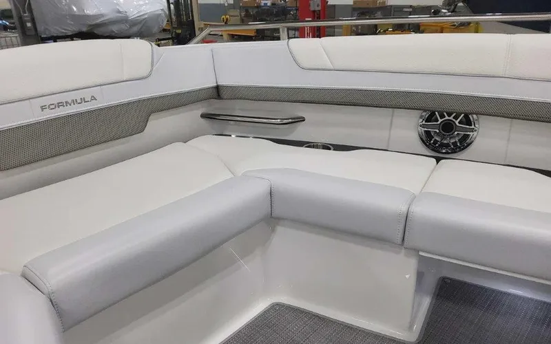 Slide: The Image of 2025 Formula 330 Crossover Bowrider I/O interior with white seating and speaker. - 27