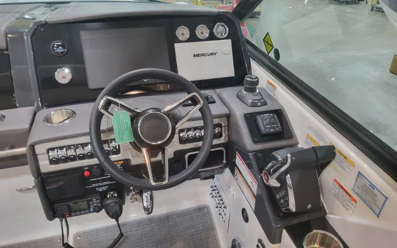 Slide: The Image of 2025 Formula 330 Crossover Bowrider I/O dashboard with steering wheel and controls. - 39