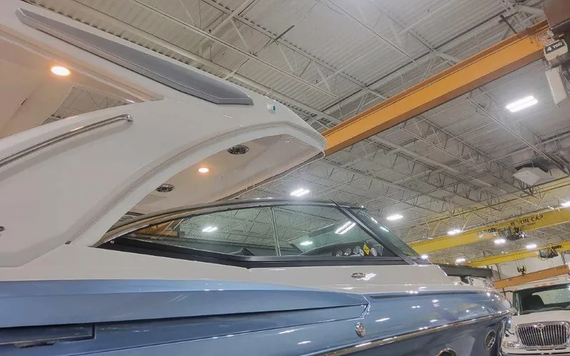 Slide: The Image of 2025 Formula 330 Crossover Bowrider I/O in a showroom, showcasing sleek design and modern features. - 4