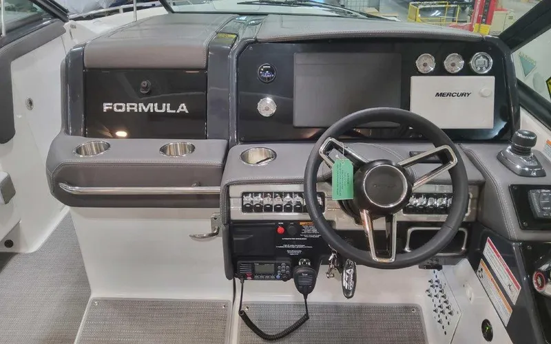Slide: The Image of 2025 Formula 330 Crossover Bowrider I/O dashboard with steering wheel and control panel. - 40