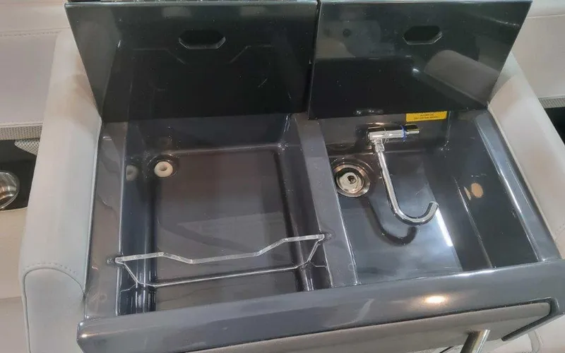 Slide: The Image of 2025 Formula 330 Crossover Bowrider I/O sink area with dual compartments and faucet. - 45