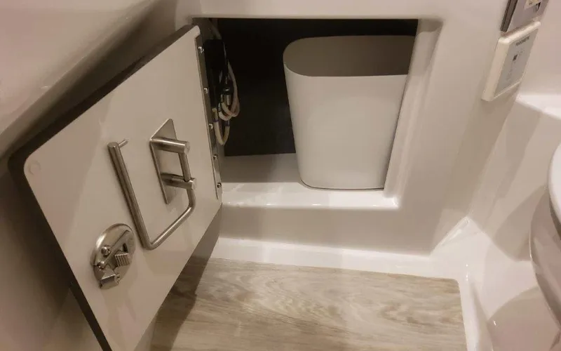 Slide: The Image of 2025 Formula 330 Crossover Bowrider I/O interior storage compartment with trash bin. - 19