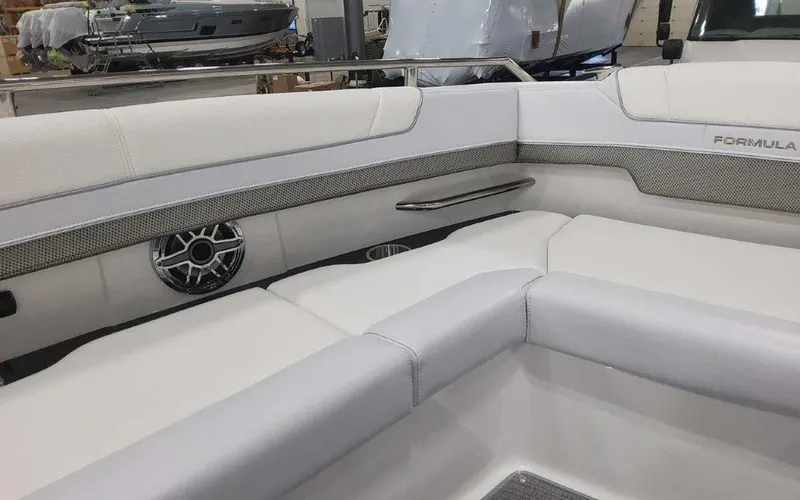 Slide: The Image of 2025 Formula 330 Crossover Bowrider I/O interior with white seating and speaker detail. - 29