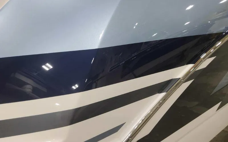 Slide: The Image of 2025 Formula 330 Crossover Bowrider I/O with sleek, modern hull design and bold stripes. - 3