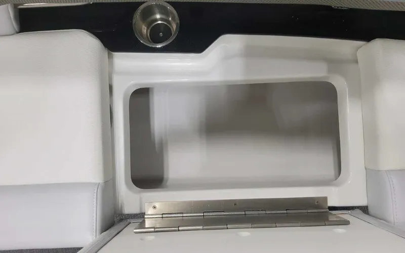 Slide: The Image of 2025 Formula 330 Crossover Bowrider I/O storage compartment with cup holder, open view. - 33