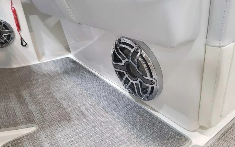 Slide: The Image of 2025 Formula 330 Crossover Bowrider I/O interior speaker detail with gray carpet flooring. - 43