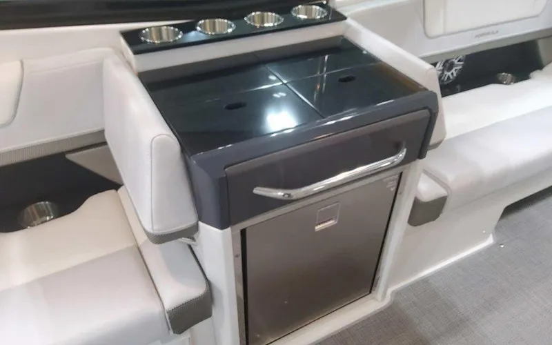 Slide: The Image of 2025 Formula 330 Crossover Bowrider I/O interior with sleek seating and built-in cup holders. - 44