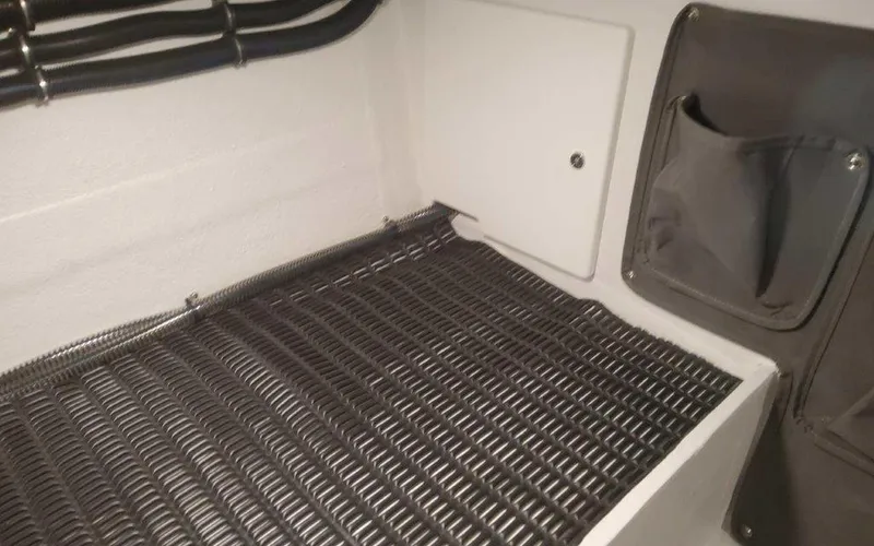 Slide: The Image of Interior view of 2025 Formula 330 Crossover Bowrider I/O, showcasing storage and utility features. - 46