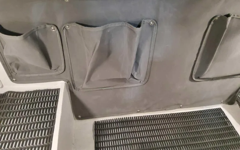 Slide: The Image of Interior storage pockets and flooring of 2025 Formula 330 Crossover Bowrider I/O boat. - 47