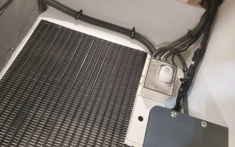 Slide: The Image of 2025 Formula 330 Crossover Bowrider I/O engine compartment with wiring and components. - 49