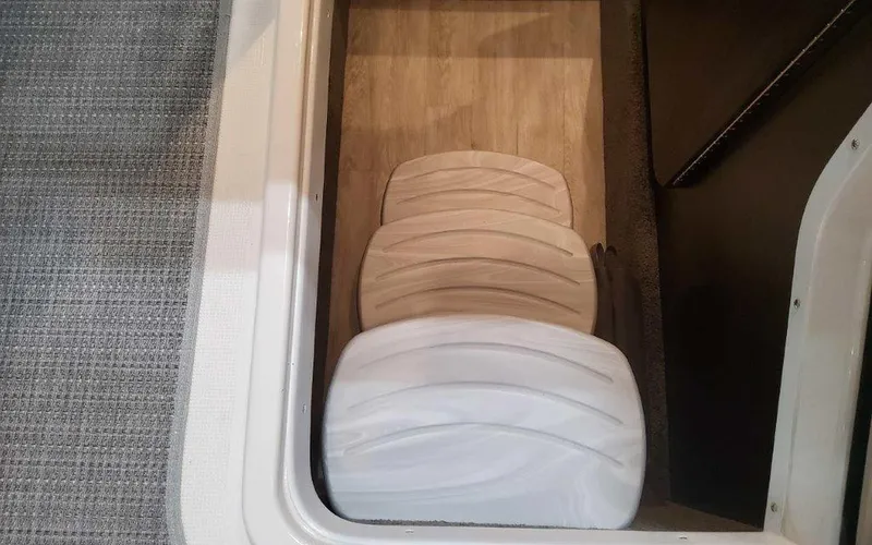 Slide: The Image of Storage compartment in 2025 Formula 330 Crossover Bowrider I/O with life jackets. - 8