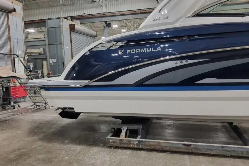 Slide: The Image of 2027 Formula 330 Crossover Bowrider I/O in a workshop setting. - 4