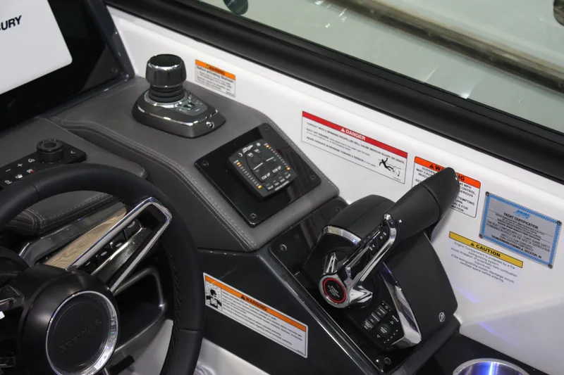 Slide: The Image of Control panel of 2027 Formula 330 Crossover Bowrider I/O with steering wheel and throttle. - 54