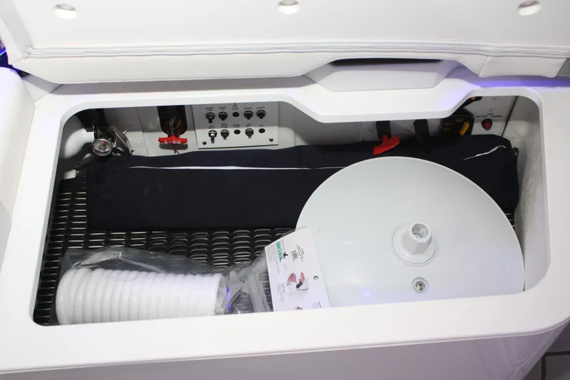 Slide: The Image of Storage compartment of 2027 Formula 330 Crossover Bowrider I/O with equipment and controls. - 21