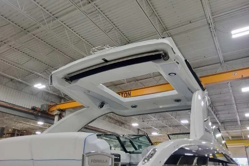 Slide: The Image of 2027 Formula 330 Crossover Bowrider I/O in a warehouse, showcasing its sleek design. - 7