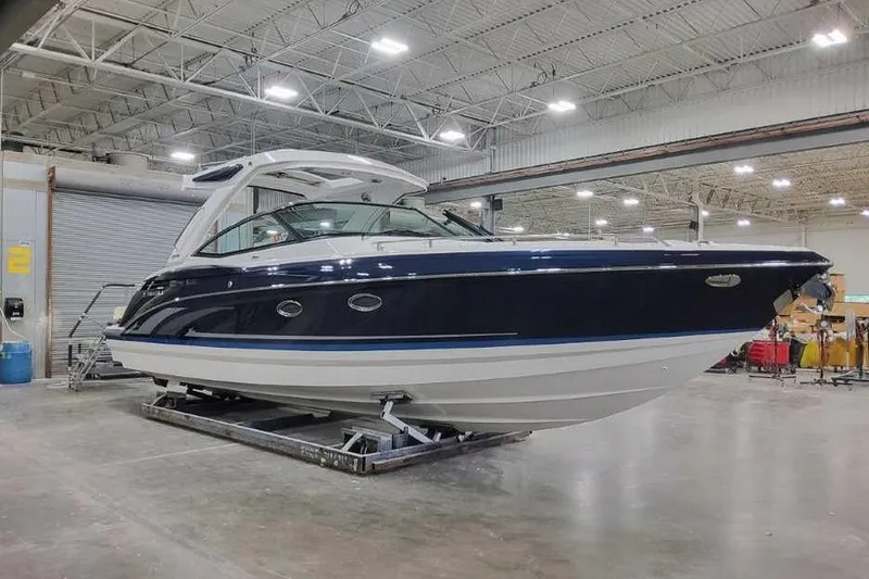 Slide: The Image of 2027 Formula 330 Crossover Bowrider I/O in a spacious indoor showroom. - 1