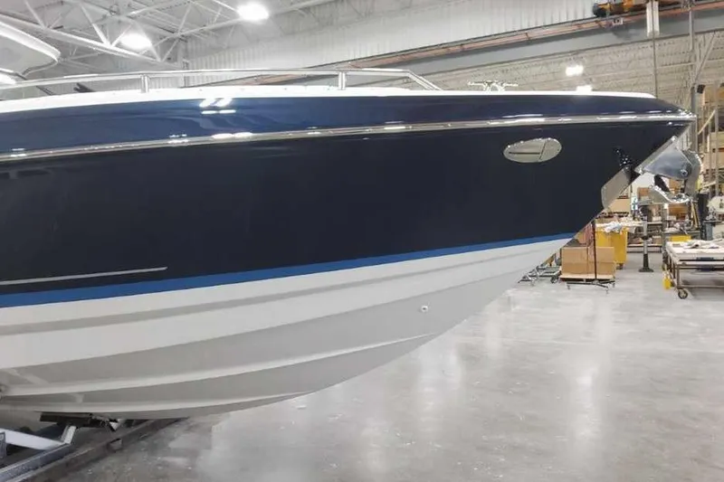 Slide: The Image of 2027 Formula 330 Crossover Bowrider I/O in a showroom, showcasing sleek design and craftsmanship. - 6