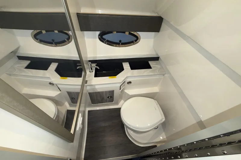 Slide: The Image of Modern bathroom in 2027 Formula 330 Crossover Bowrider I/O boat, featuring sleek fixtures and porthole windows. - 42