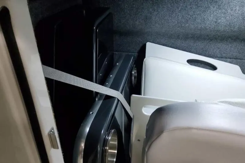 Slide: The Image of Storage compartment in 2027 Formula 330 Crossover Bowrider I/O boat, featuring secured items. - 32