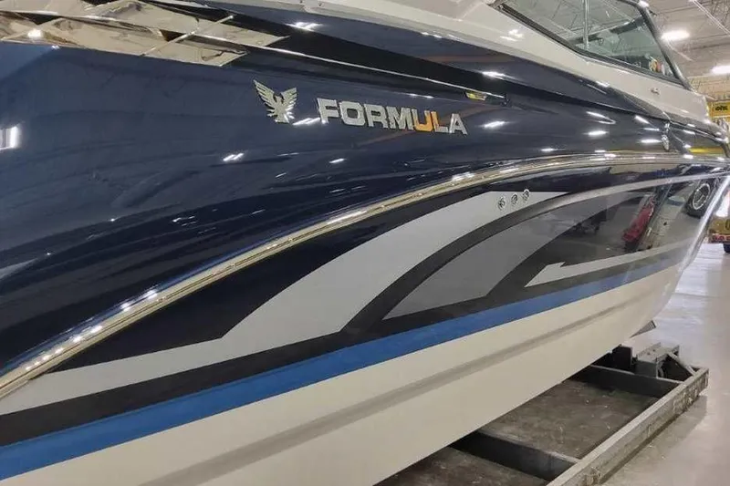 Slide: The Image of 2027 Formula 330 Crossover Bowrider I/O boat with sleek blue and white design. - 5