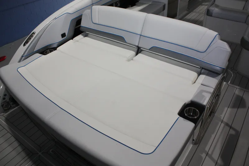Slide: The Image of 2027 Formula 330 Crossover Bowrider I/O with spacious white seating and cup holders. - 12
