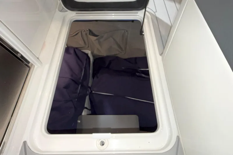 Slide: The Image of Storage compartment in 2027 Formula 330 Crossover Bowrider I/O boat, featuring organized interior space. - 27
