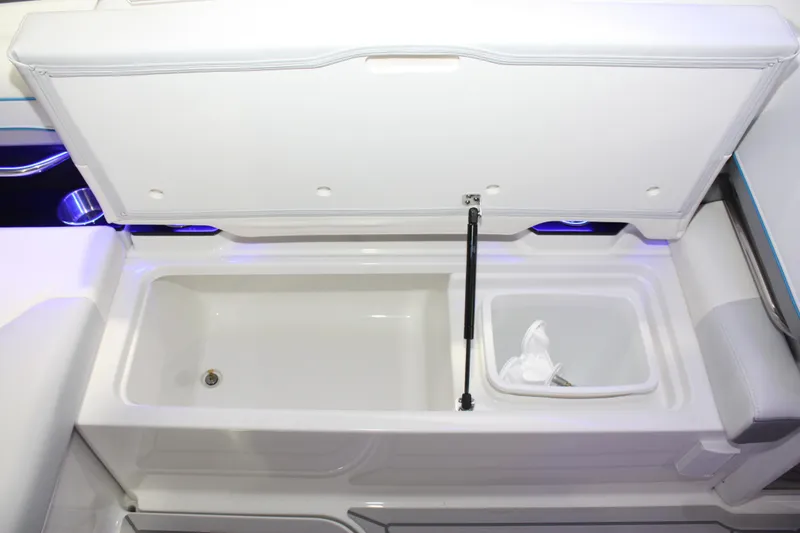 Slide: The Image of 2027 Formula 330 Crossover Bowrider I/O storage compartment with open lid and hydraulic support. - 18