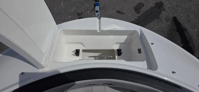 Slide: The Image of 2025 Sea Ray SPX 190 boat storage compartment with open lid, showcasing interior space. - 14