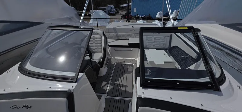 Slide: The Image of 2025 Sea Ray SPX 190 boat interior with open windshield and seating area. - 16