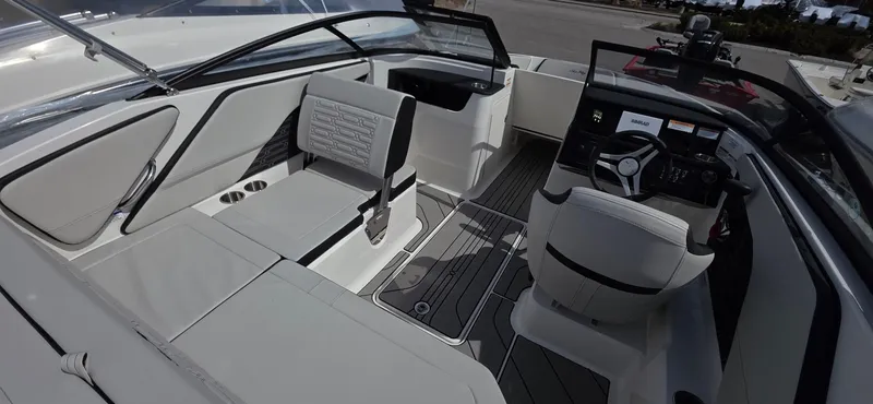 Slide: The Image of 2025 Sea Ray SPX 190 boat interior with modern seating and sleek dashboard design. - 9