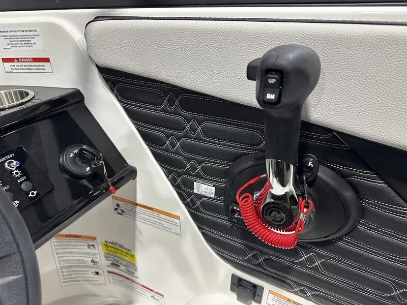 Slide: The Image of 2025 Sea Ray SPX 190 OB boat interior with control panel and throttle lever. - 13