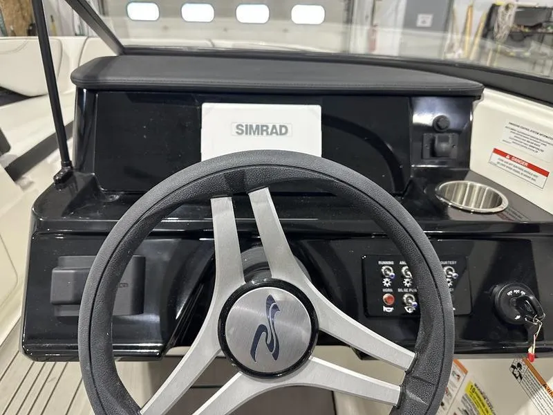 Slide: The Image of Steering wheel and dashboard of 2025 Sea Ray SPX 190 OB boat with Simrad display. - 14