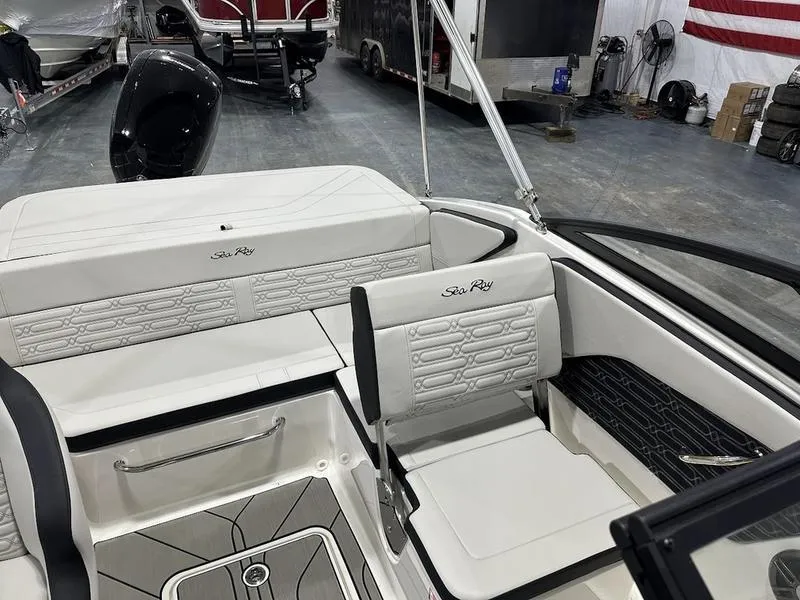 Slide: The Image of 2025 Sea Ray SPX 190 OB boat interior with white seating and sleek design. - 4