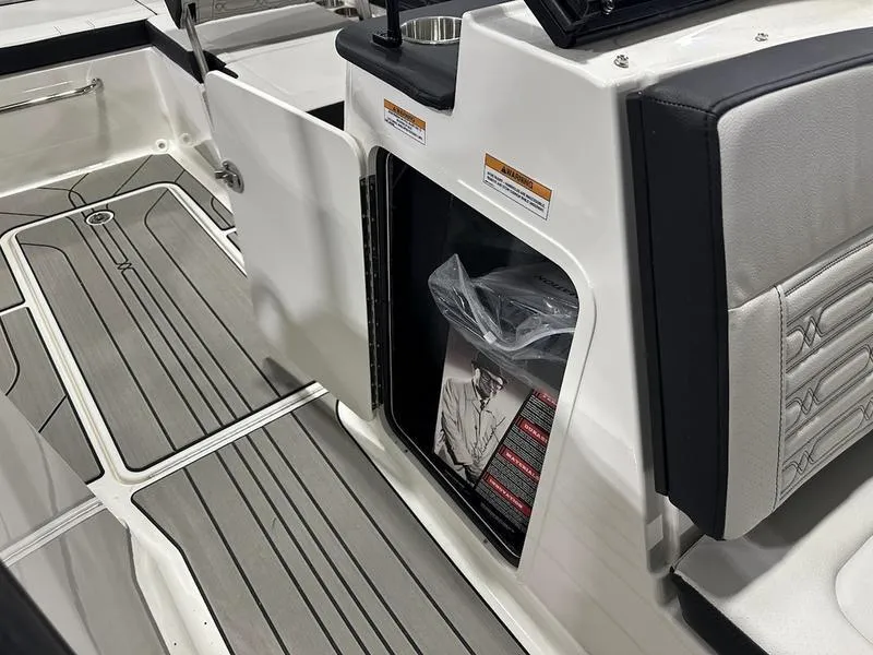 Slide: The Image of 2025 Sea Ray SPX 190 OB boat interior with storage compartment and sleek flooring. - 7