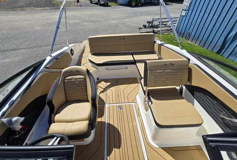 Slide: The Image of 2025 Sea Ray SPX 210 boat interior with tan seating and sleek design. - 3