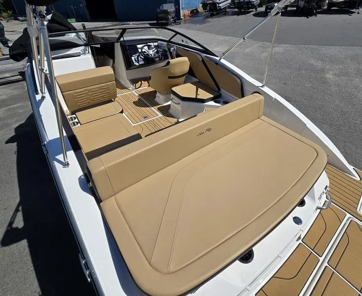 Slide: The Image of 2025 Sea Ray SPX 210 boat interior with tan seating and modern design. - 4