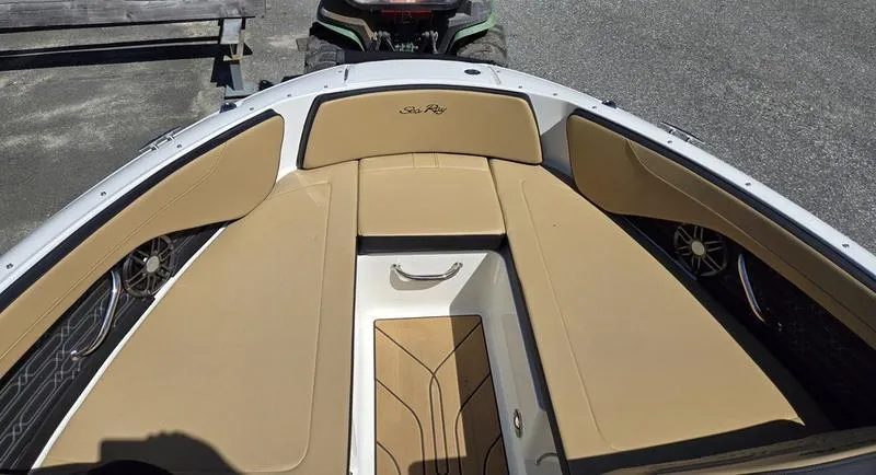 Slide: The Image of 2025 Sea Ray SPX 210 boat interior with tan seating and sleek design. - 6
