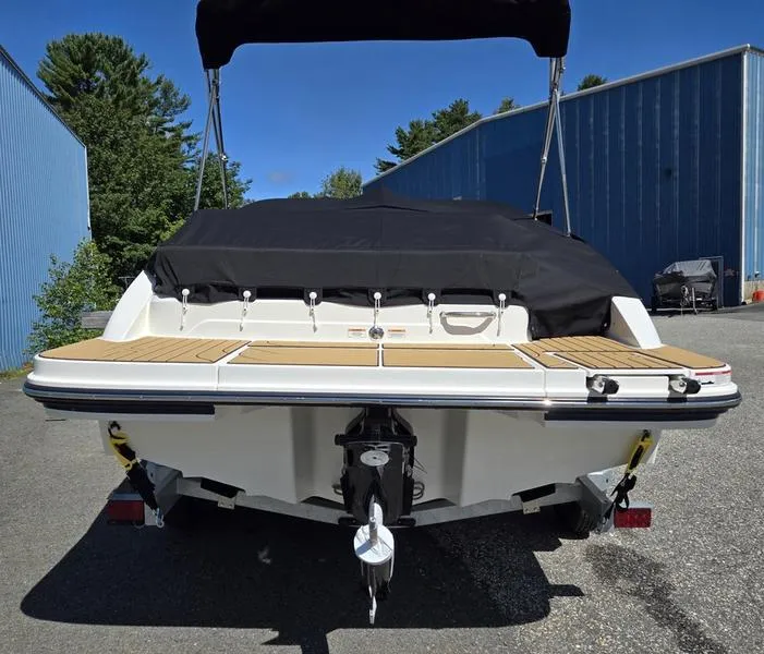 Slide: The Image of 2025 Sea Ray SPX 210 boat, rear view, covered, parked outdoors. - 7