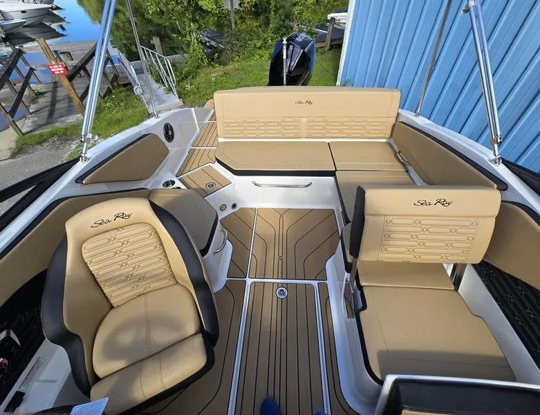 Slide: The Image of 2025 Sea Ray SPX 210 Outboard boat interior with tan seating and sleek design. - 5