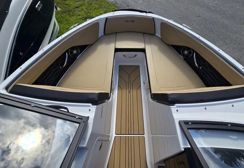 Slide: The Image of 2025 Sea Ray SPX 210 Outboard boat on trailer, parked outdoors. - 6