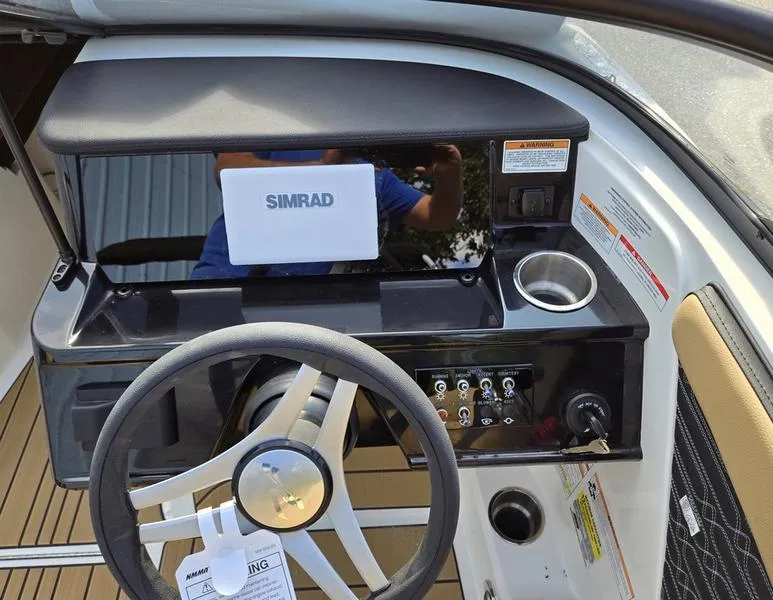 Slide: The Image of 2025 Sea Ray SPX 210 Outboard interior with tan seating and sleek design. - 7