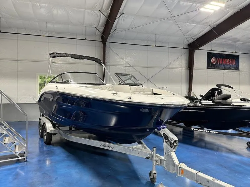 Slide: The Image of 2025 Sea Ray SPX 210 OB boat on trailer in showroom. - 12