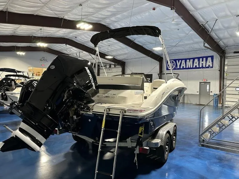 Slide: The Image of 2025 Sea Ray SPX 210 OB boat in showroom, featuring Mercury outboard motor. - 4