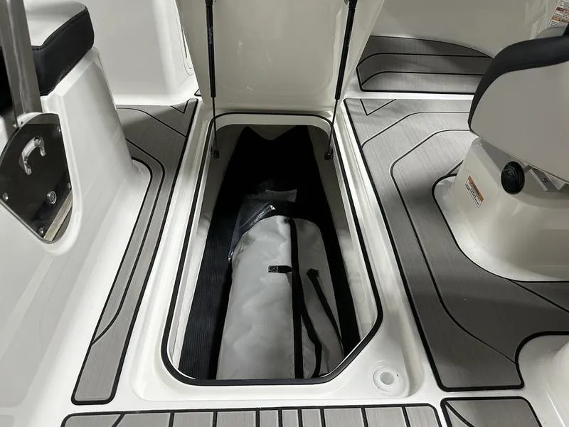 Slide: The Image of 2025 Sea Ray SPX 210 OB boat interior storage compartment with open hatch. - 5